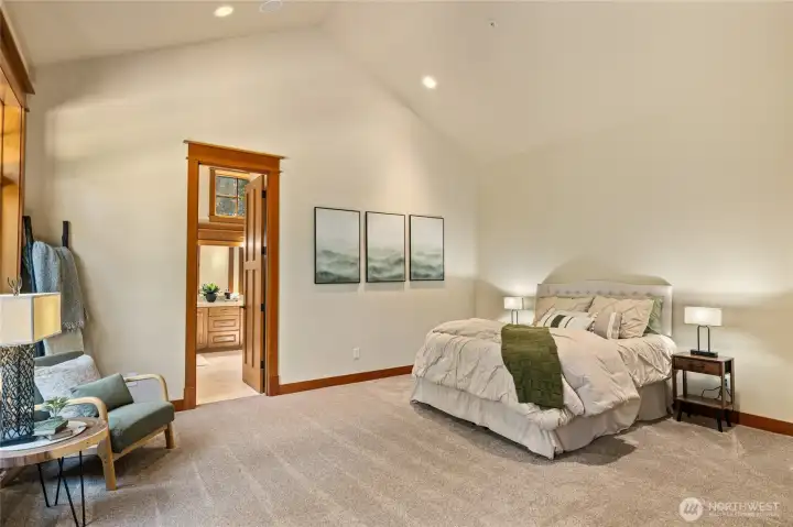 Large primary bedroom with door out to deck