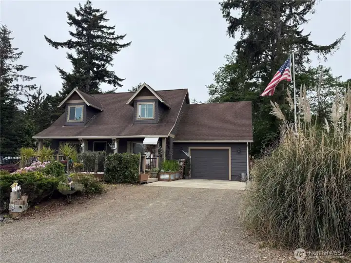 Front of house with flag pole and side yard