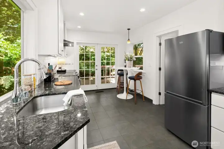 Remodeled kitchen opening to expansive back deck