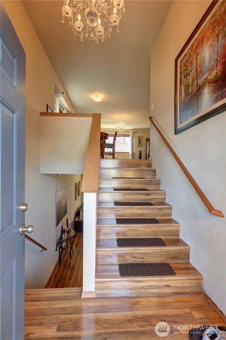 Step into a bright, open entry with soaring ceilings, beautiful flooring, and an elegant chandelier that creates a grand first impression. Step into a bright, open entry with soaring ceilings, beautiful flooring, and an elegant chandelier that creates a grand first impression.