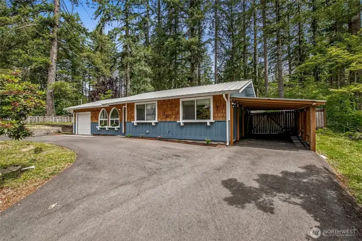 Garage, carport and a circular drive makes for ample parking options