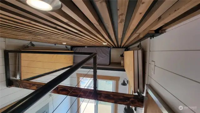 Looking across to the 2nd loft floor that is cranked up to accommodate a hammock or just give height to the living area.