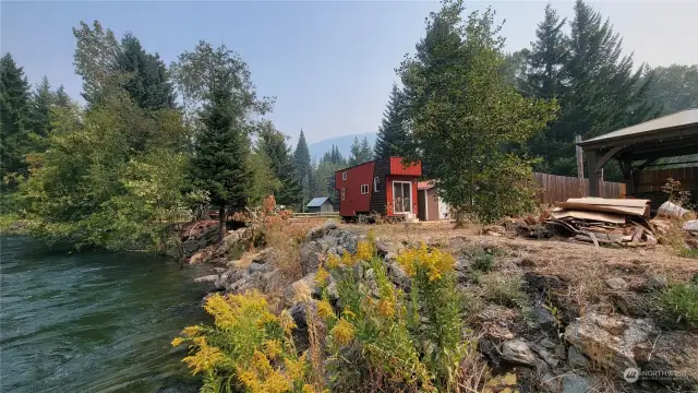 Another view of the tiny home and the river bank.