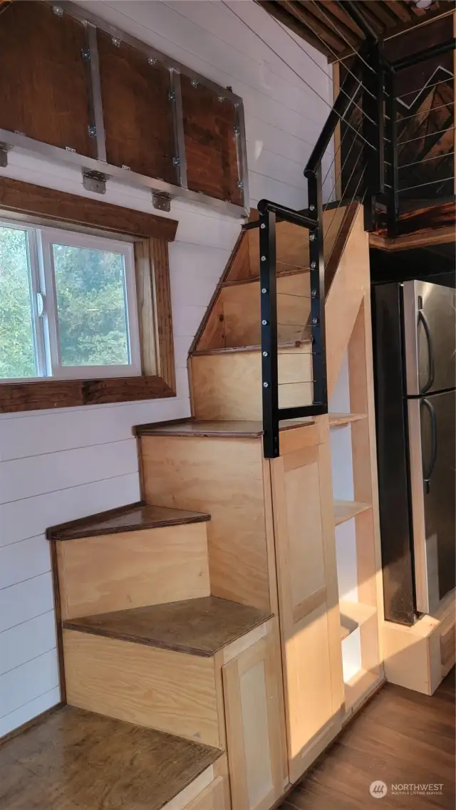 The stairway is actually storage as well. The fold down catwalk is above the window to give access to the 2nd bedroom.