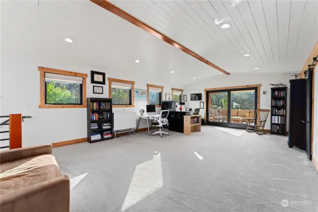 Upper level loft office area w/ glass sliding doors leading to the view deck w/ fireplace.