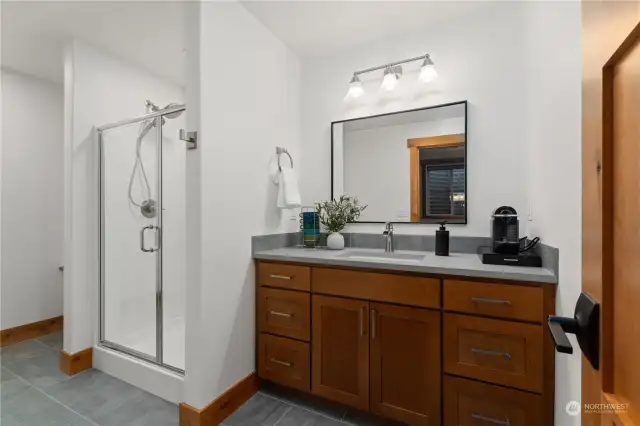 Lower level guest bathroom w/ ceramic tile & quartz countertops.