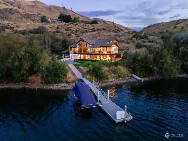 Aerial twilight view of home with 535' of waterfront on the Columbia River with private dock and 9,000lb boat lift on 12 acres.