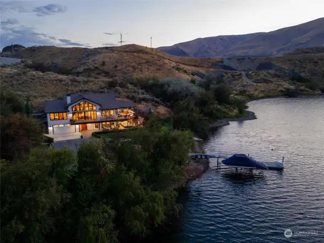 Aerial twilight view of home on 535' of waterfront on the Columbia River w/ private dock w/ boat lift and surrounding landscape on 12 acres.