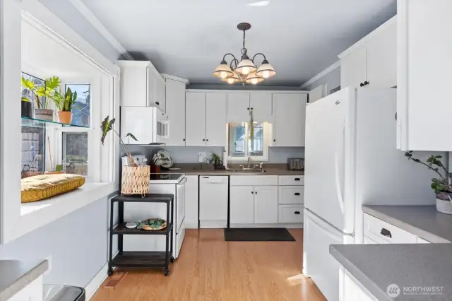 Updated kitchen does allow room for a small sit-in table.