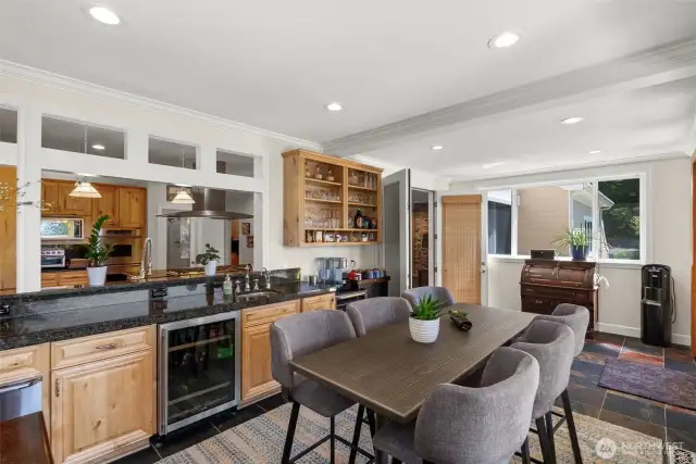 Kitchen looks out to 4-season, sunroom with warming drawers, wine refrigerator heating & cooling