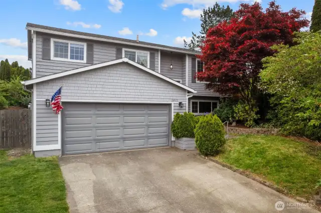 Front of home with 2 car attached garage.