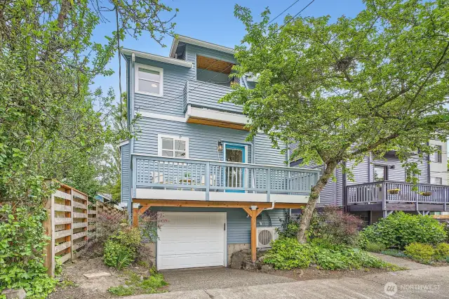 Paved alley off the back of the home has garage entrance and room for an additional small car in driveway if desired
