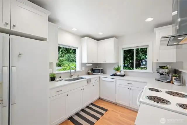 The kitchen is a true standout with quartz countertops, a walk-in pantry, and modern finishes.