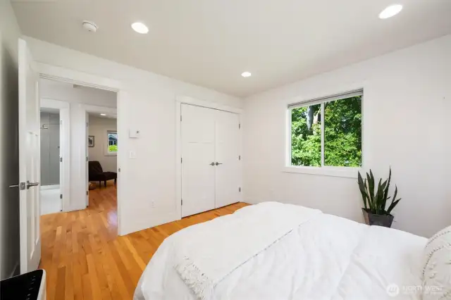 A custom closet system adds smart storage to the primary  bedroom.