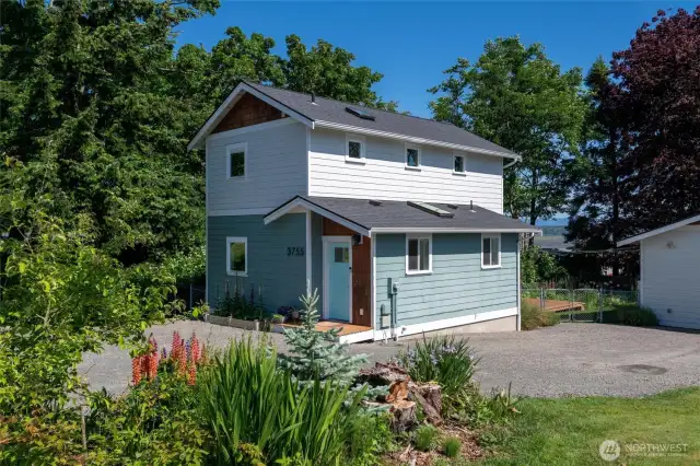 Vibrant landscaping surrounds the property.
