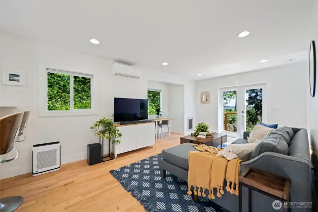 Spacious living room wtih maple hardwood floors, air conditioning and lots of natural light.