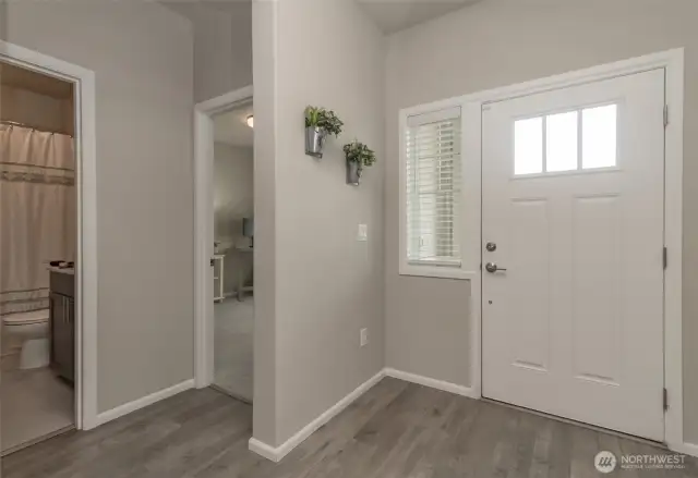 Another view of front entry with 2 bedrooms and a full bathroom on the left