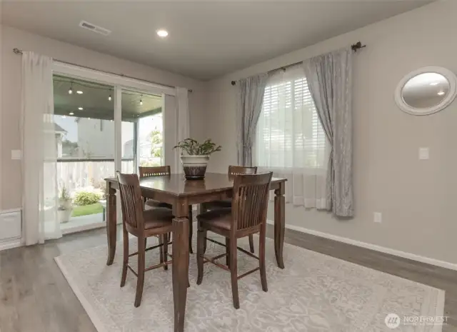 Large dining area with entry through oversized sliding glass doors out to covered patio