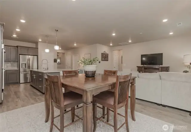 View from dining area into kitchen on left and living room on right
