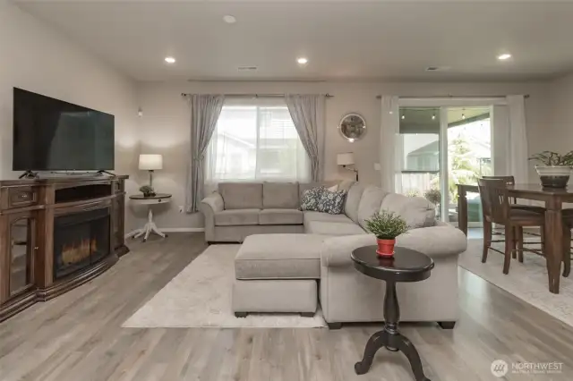 Living room is spacious and bright. Notice the gorgeous laminate flooring throughout