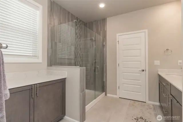 Large walk-in shower and storage area with counter on left