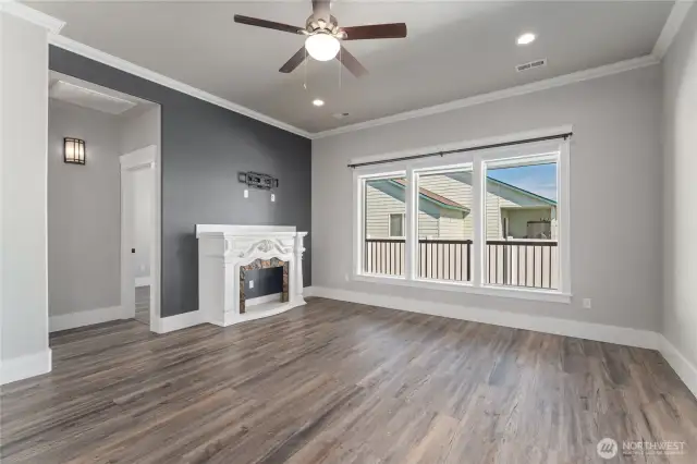 Warm and welcoming, the cozy living room is filled with natural light from expansive windows—creating the perfect retreat for relaxation and gathering