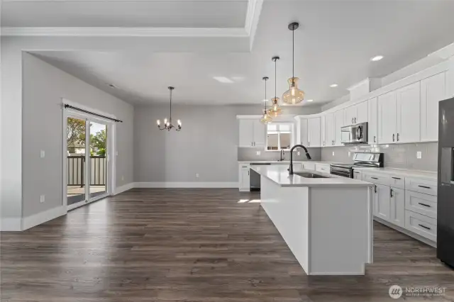 the open floor plan centers around a generous island eating bar and extends effortlessly to the covered rear deck—inviting indoor-outdoor gatherings all year long