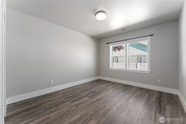 A spacious retreat featuring elegant LVP flooring and designer paint—combining comfort and elegance