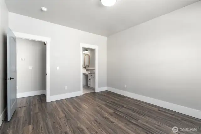 A tranquil primary suite offering generous space, elegant finishes, and abundant natural light for the ultimate retreat