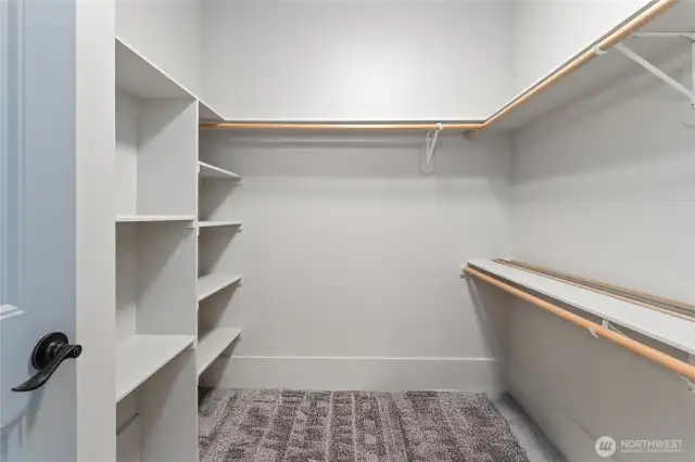 Spacious and smartly organized, this walk-in closet offers ample storage with built-in organizers for effortless style and order