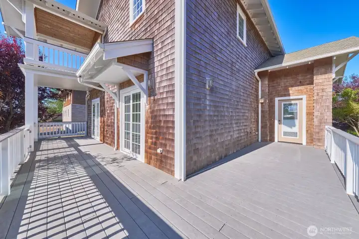 Sunny east facing deck wraps around on the north side to the entry.