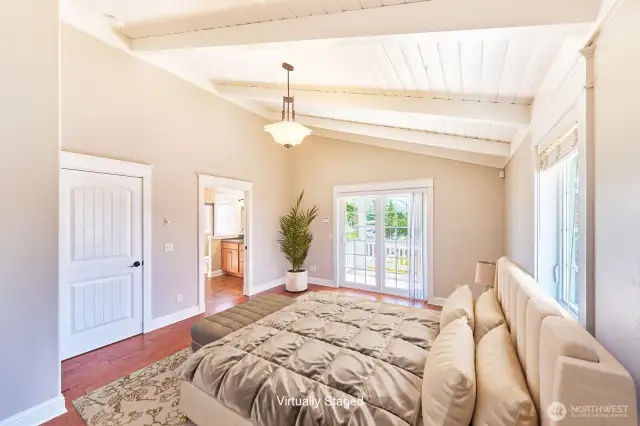 Primary bedroom has beautiful vaulted ceilings and lots of light.