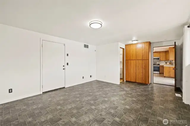 Bonus room. Entrance into garage on the left. Half bath. Built in cabinets. Entrance into kitchen.