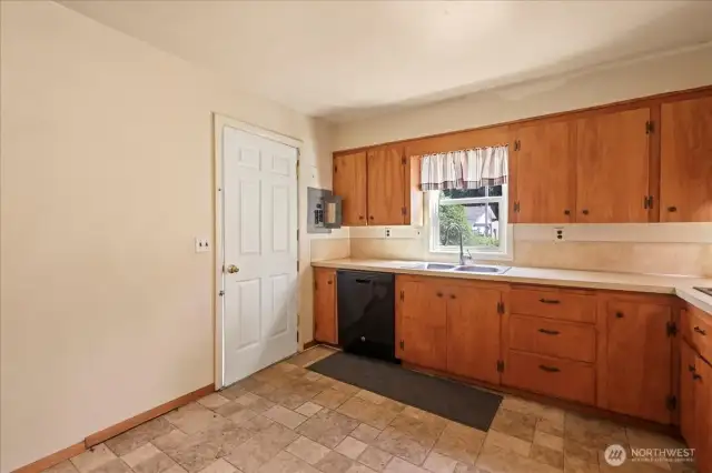 Kitchen with door to side yard near detached garage.