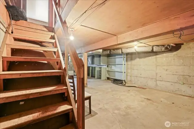 Basement stairs lead to kitchen and additional access from the rear of the home.