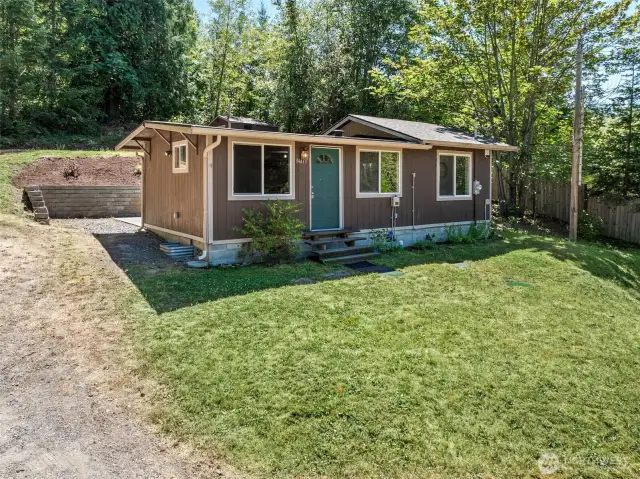 Septic pump and tanks are at the front of the home. Septic drain field is at the top of the property and follows the property line. Well is behind the home and has a 15 gpm flow.