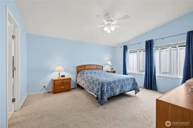 Light and airy primary bedroom offers a calm inviting retreat