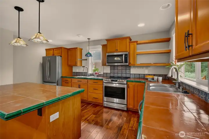 Beautiful tile work, stained glass lights and pops of color that make this kitchen warm and inviting.