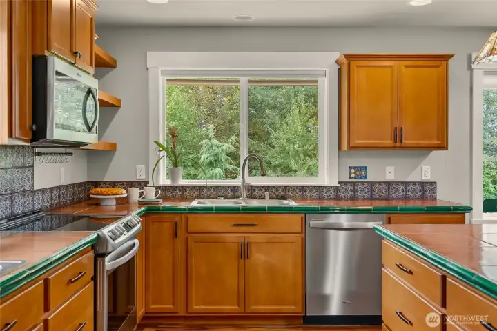 Main sink looks out to the back yard and deck
