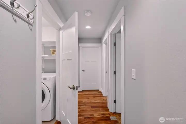 Hallway, that enters off the garage, has the two other bedrooms, bathroom and spacious laundry room.