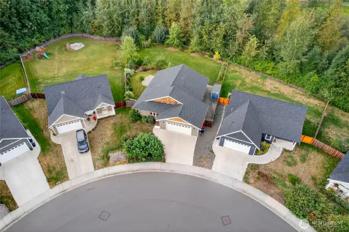 You can see the large covered front porch. It is the house with wood on the front.