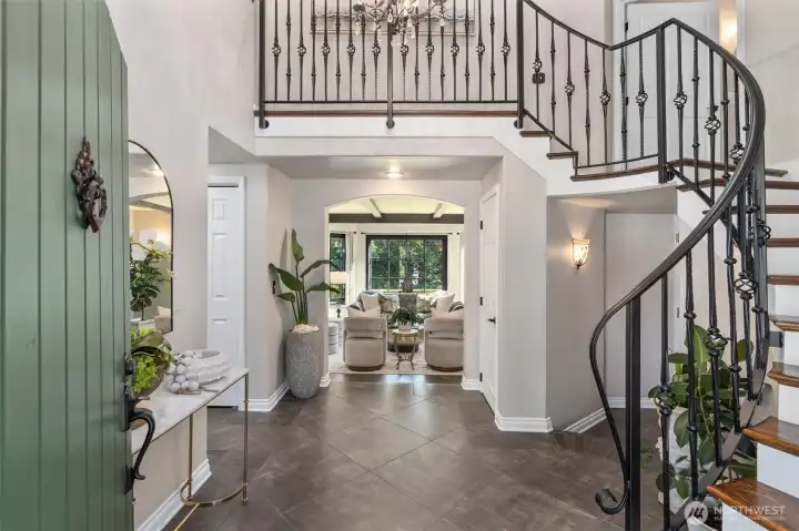 Soaring ceilings and grand staircase greet you in the foyer.