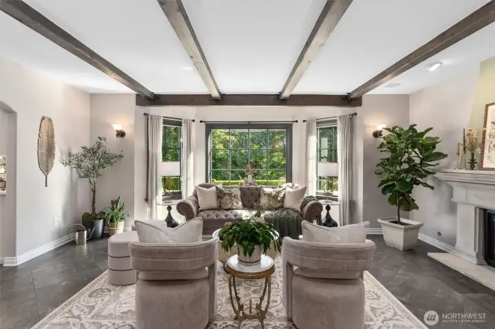 While large picture windows beckon you into your formal living room.