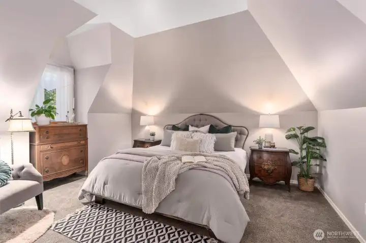 Primary bedroom has vaulted ceilings and alcove windows Primary bedroom (with king sized bed).