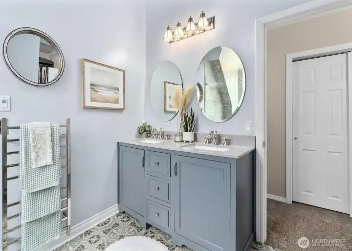 Ensuite bathroom with double sinks, heated towel rack and walk-in closet.