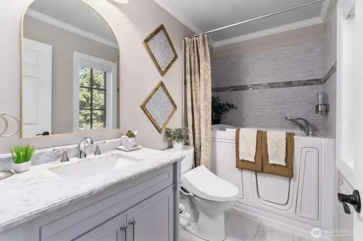 Guest bathroom with jetted walk-in spa tub.