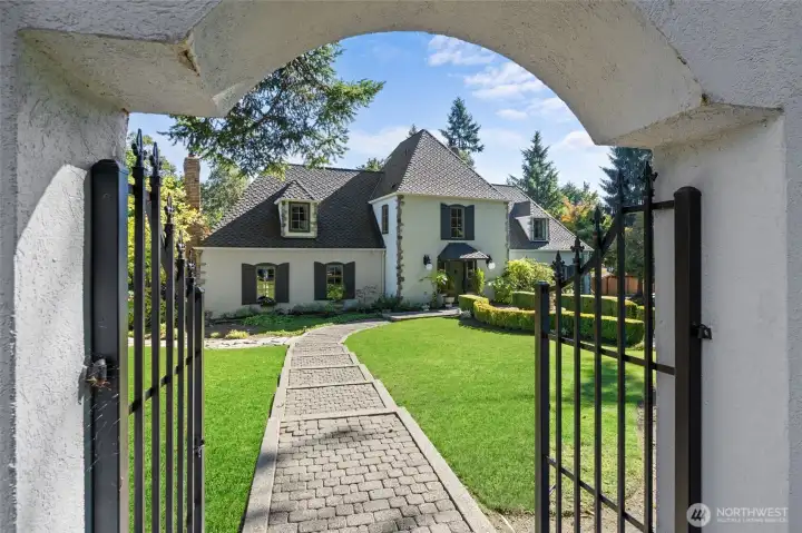 With charming wrought iron gate and lighted cobblestone paths.