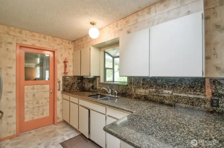 Another view of kitchen showing the garden window over the sink