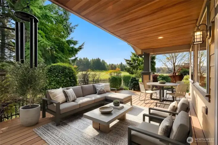 Secret garden–style, fully fenced yard with stunning views of the 12th fairway, featuring a covered Trex deck, custom outdoor lighting, drip and sprinkler systems, and two large arbors, an enchanting outdoor retreat for relaxing or entertaining.