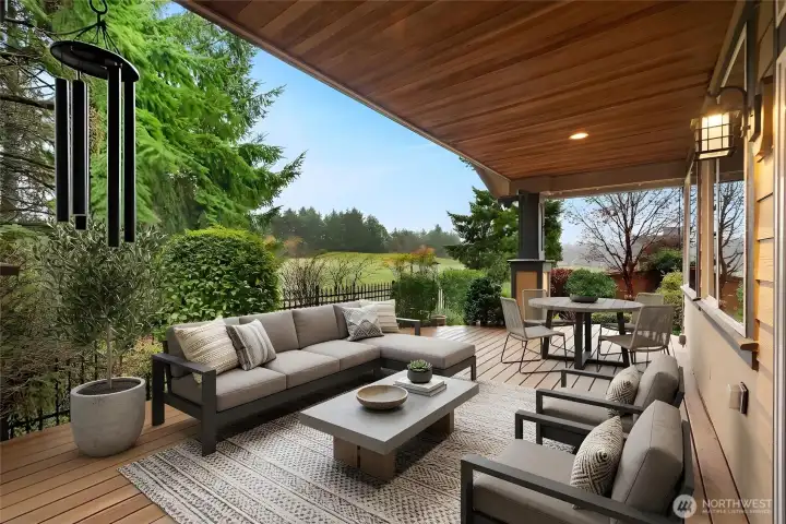 Secret garden–style, fully fenced yard with stunning views of the 12th fairway, featuring a covered Trex deck, custom outdoor lighting, drip and sprinkler systems, and two large arbors, an enchanting outdoor retreat for relaxing or entertaining.